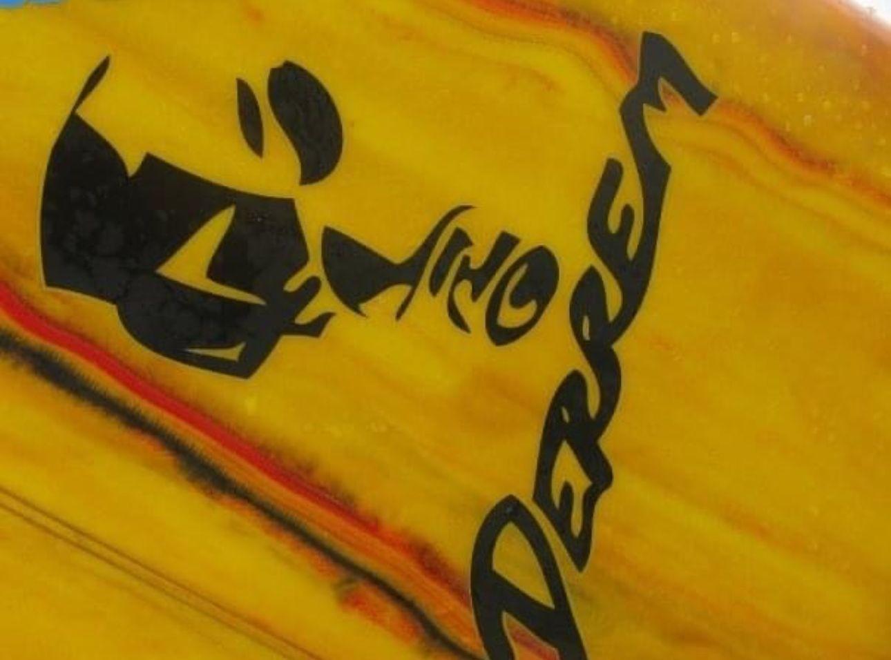 Close-up of abstract black text and logo on a vibrant yellow surface.